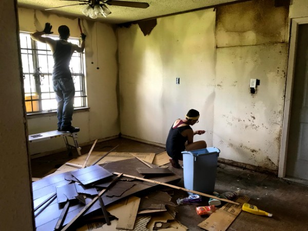 Organizing in Houston often links to mutual aid: Harvey victim and contractor-in-training and
an allied organizer work on a Northeast Action Collective’s member's house 2 years after Harvey to
remove all mold as the first stage of a West Street Recovery (WSR) full repair. (Photo credit: WSR Staff)